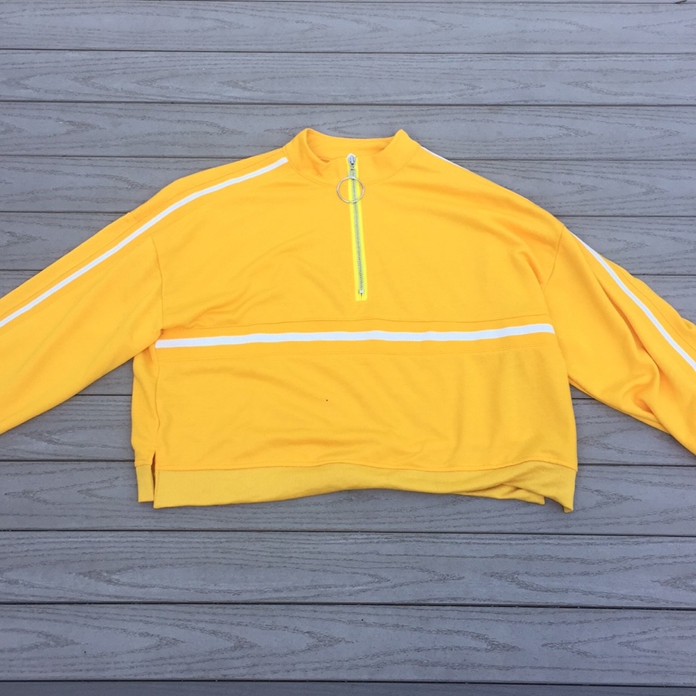 Mustard yellow crop top with circular zipper.